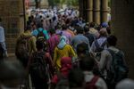 Commuters exit the Chhatrapati Shivaji Maharaj Terminus railway station in Mumbai, India.