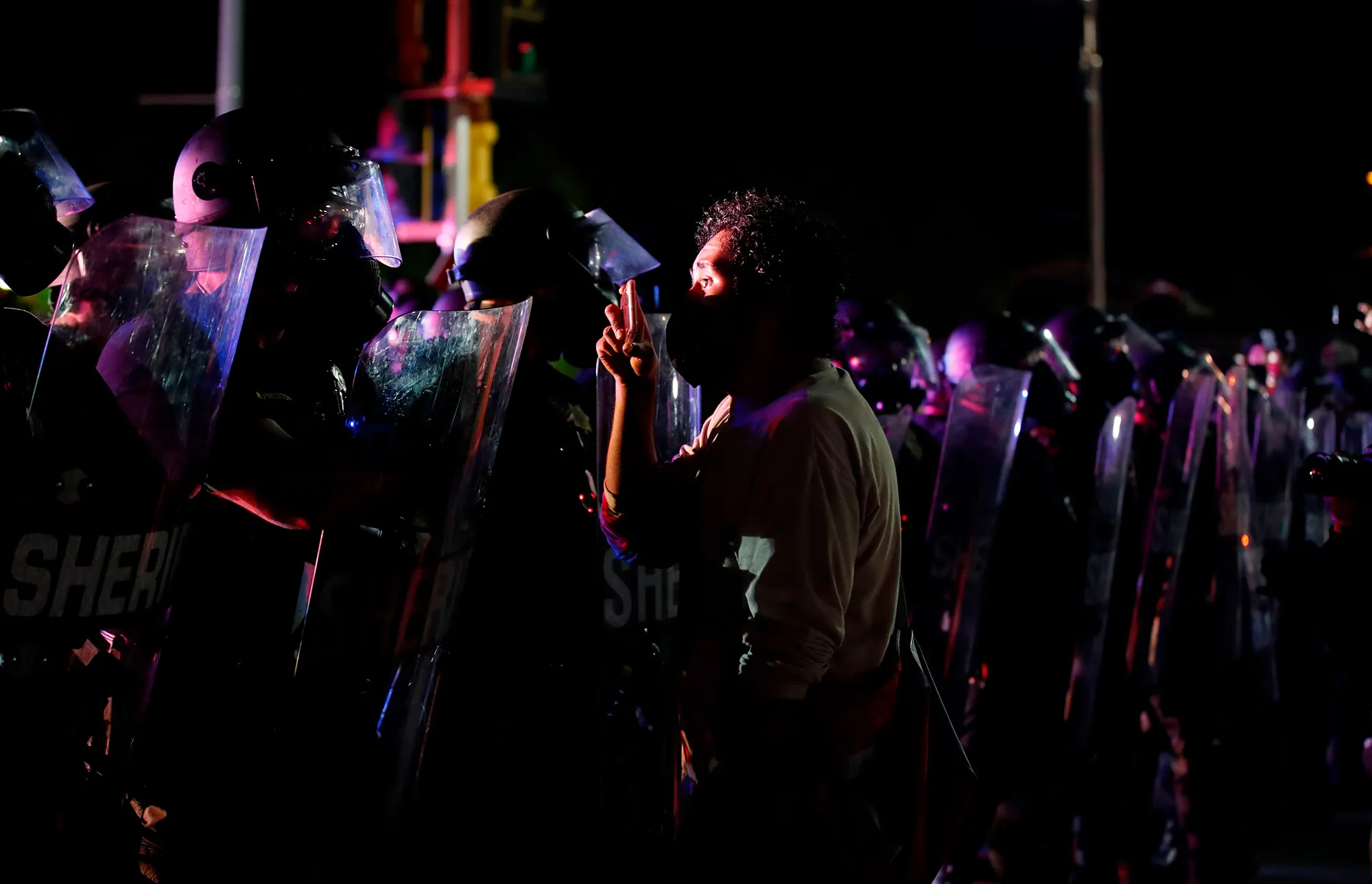 Protestors face police outside the County Courthouse during demonstrations in Kenosha, Wisconsin, on Aug. 25.
