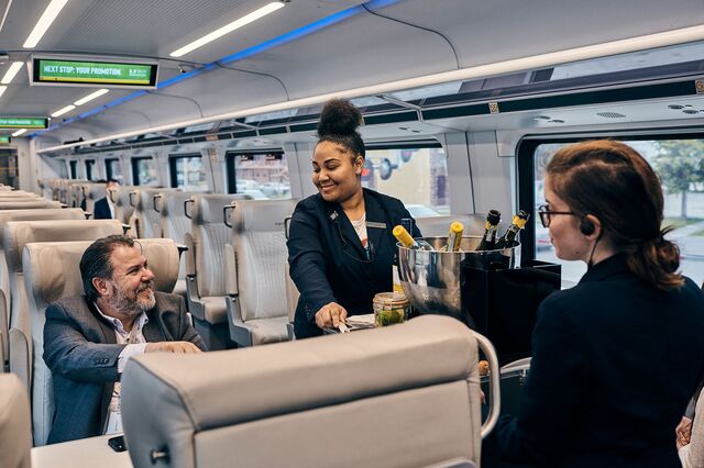 Brightline's onboard service, train attendants offering snacks and beverages to passengers on the train from Fort Lauderdale to Miami. Florida, January 10, 2020