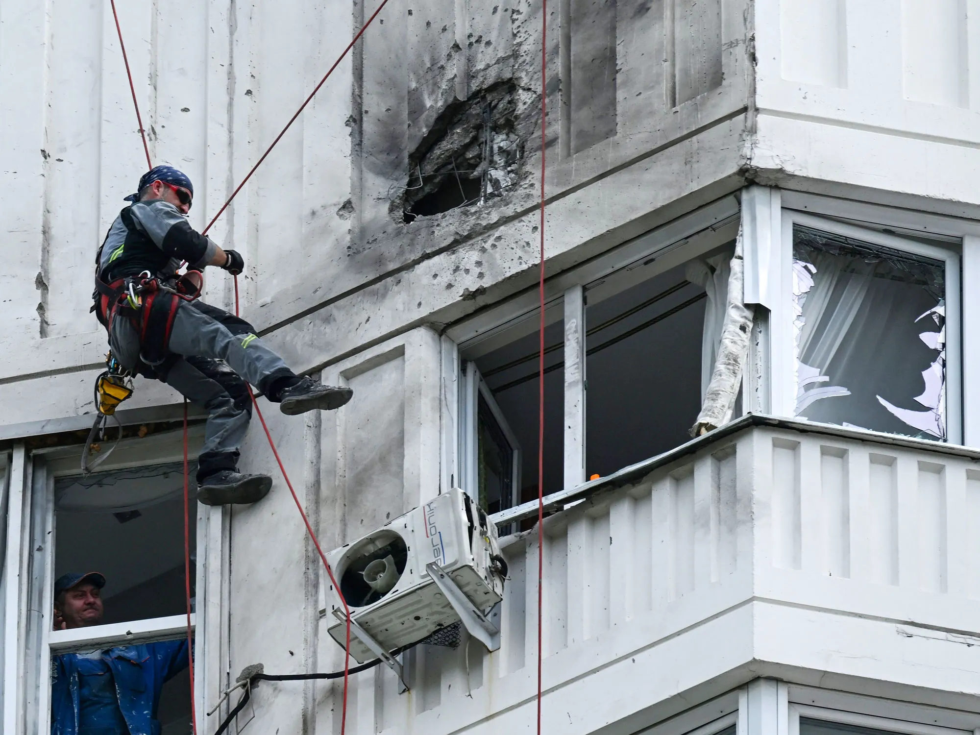 Damage is inspected following a reported drone strike on an apartment building in Moscow on May 30.