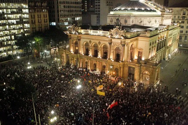 People protest in front of the Municipal Theatre of Sao Paulo against a bus fare increase on June 13, 2013