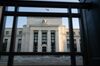 The Marriner S. Eccles Federal Reserve building stands behind a fence in Washington, D.C., U.S., on Tuesday, Aug. 18, 2020. In addition to helping rescue the U.S. economy amid the coronavirus pandemic, Fed Chair Jerome Powell and colleagues also spent 2020 finishing up the central bank’s first-ever review of how it pursues the goals of maximum employment and price stability set for it by Congress.