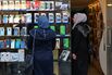 Customers browse mobile phones at a shop in Damascus.