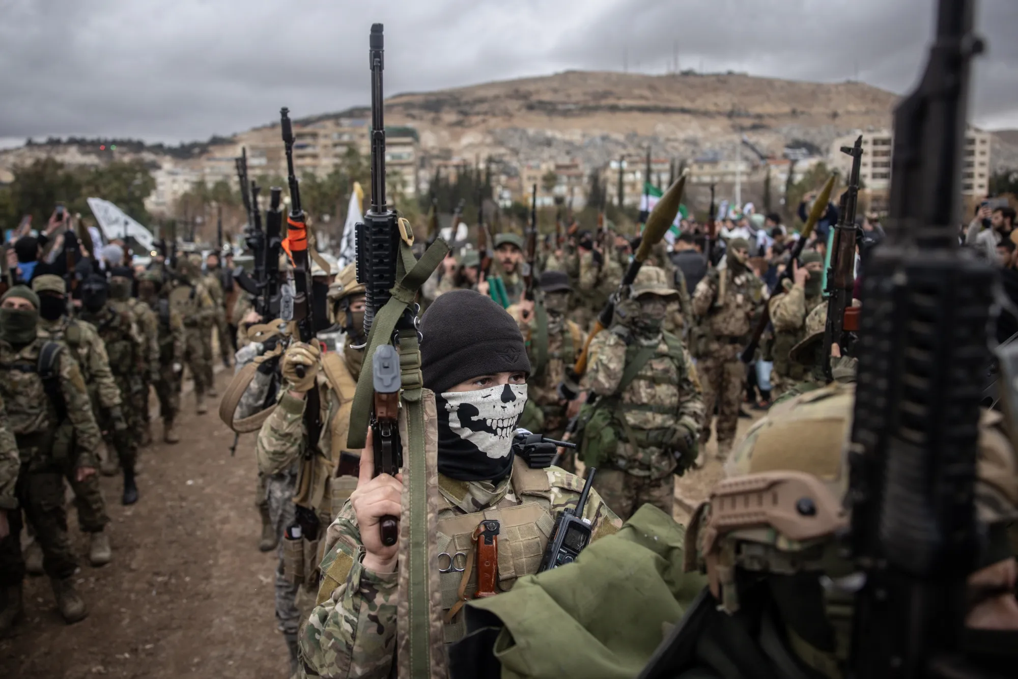 Soldiers from Hayat Tahrir al-Sham march through Umayyad Square during a mourning demonstration in Damascus on Dec 27.