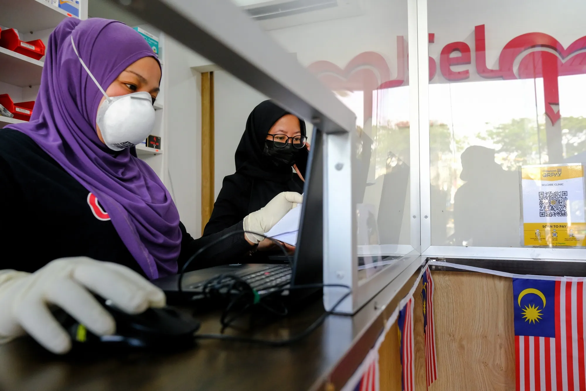 Health workers at a Covid-19 testing center at a Selcare clinic in Shah Alam, Selangor, Malaysia.