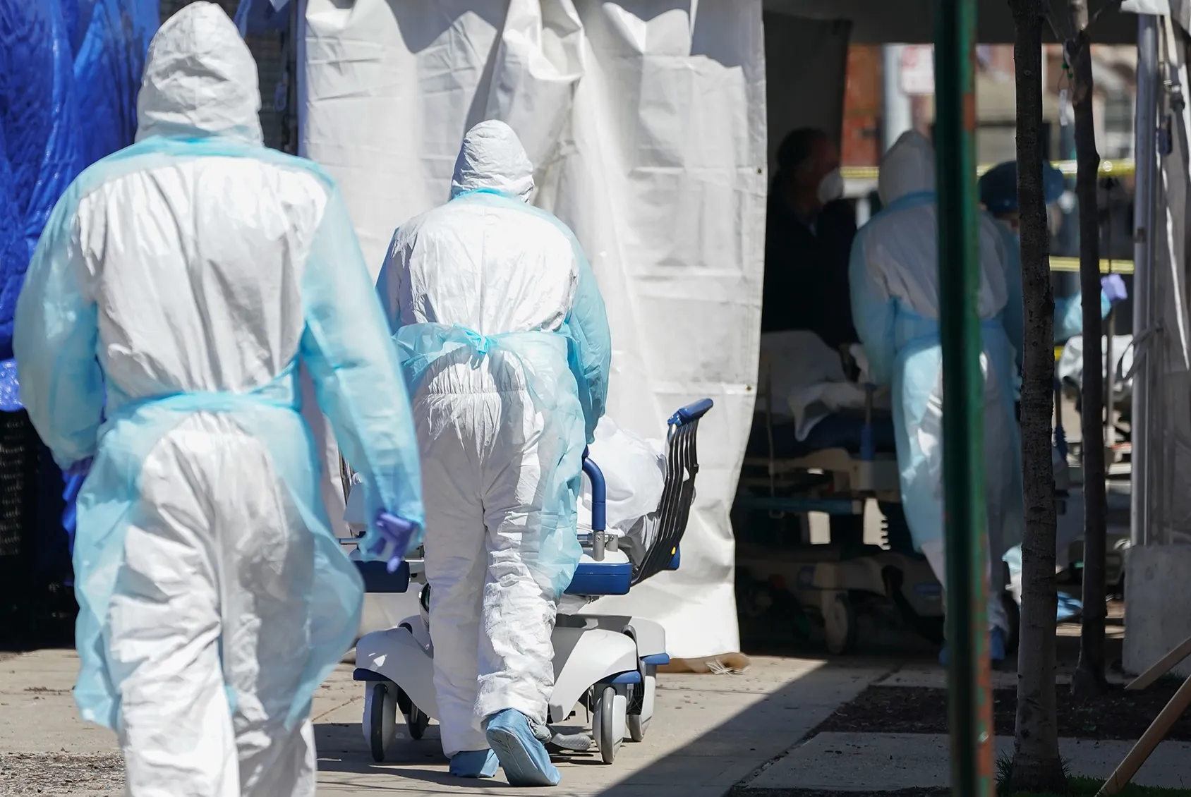 Bodies are moved to a refrigeration truck serving as a temporary morgue at Wyckoff Hospital in Brooklyn, New York on April 6.