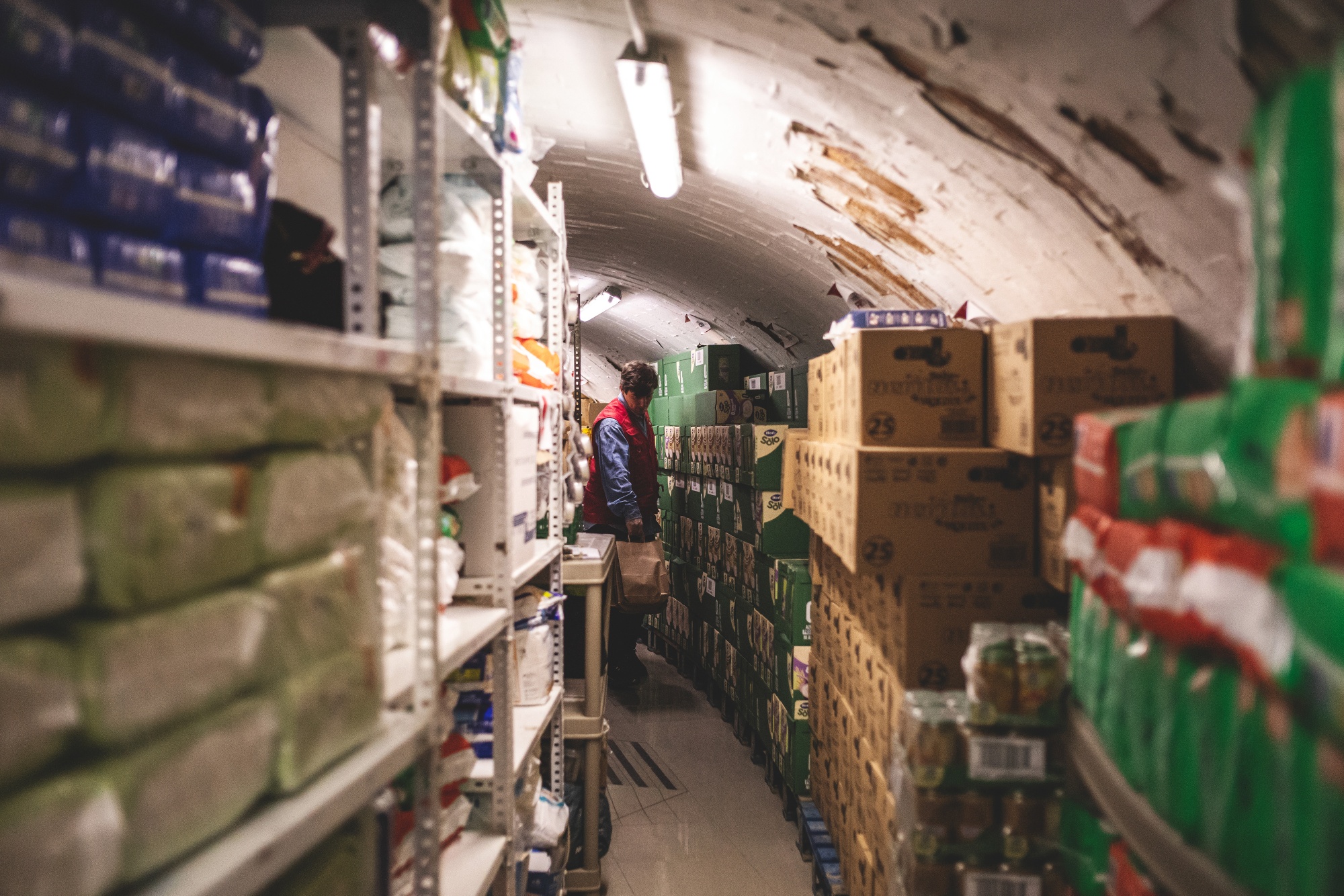 A volunteer carries goods out of a storage area at the Fundacion Madrina in Madrid, Spain, on Friday, March 13, 2026.