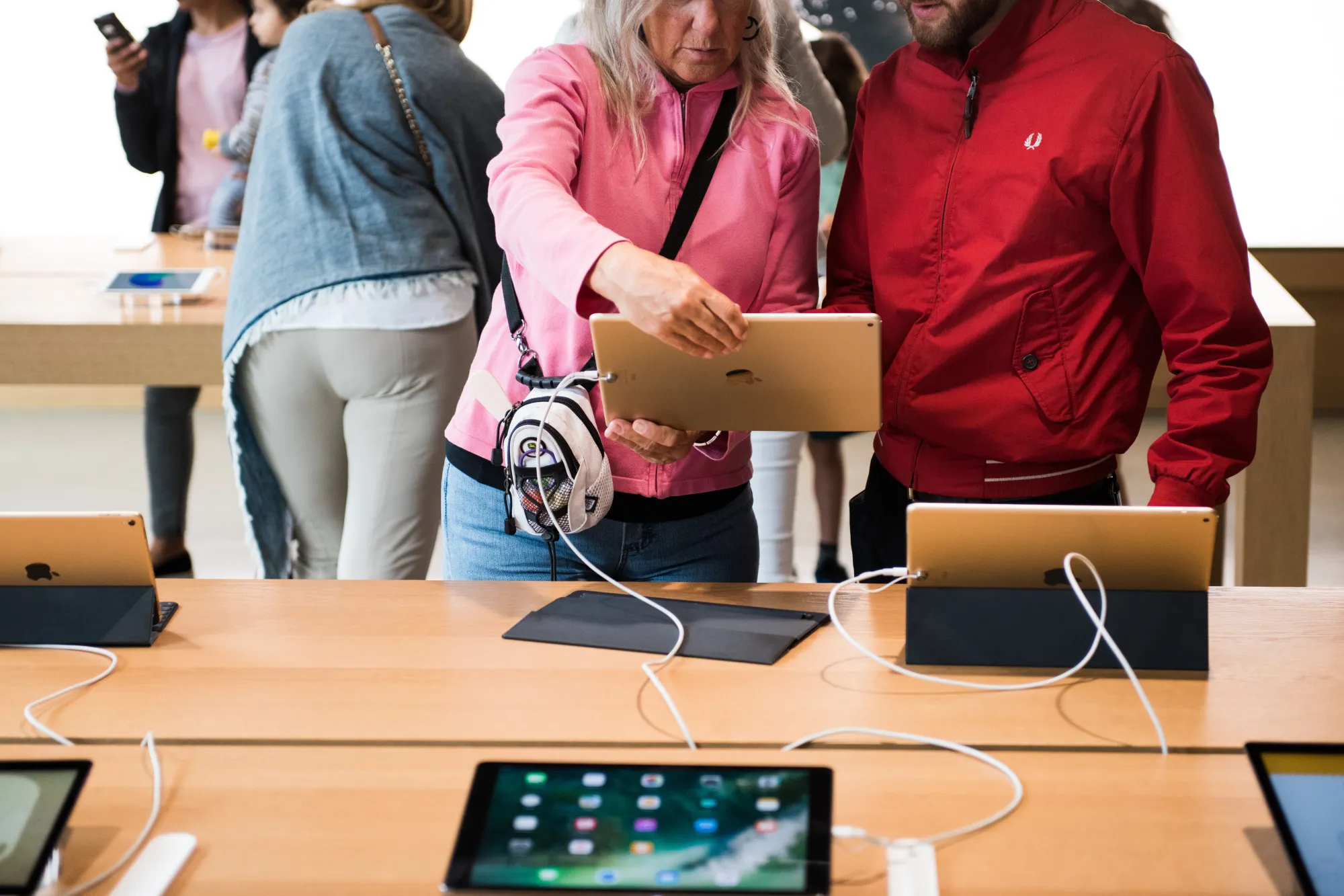 Customers view an Apple Inc. iPad Pro tablet at the company's Williamsburg store in the Brooklyn borough of New York, U.S.