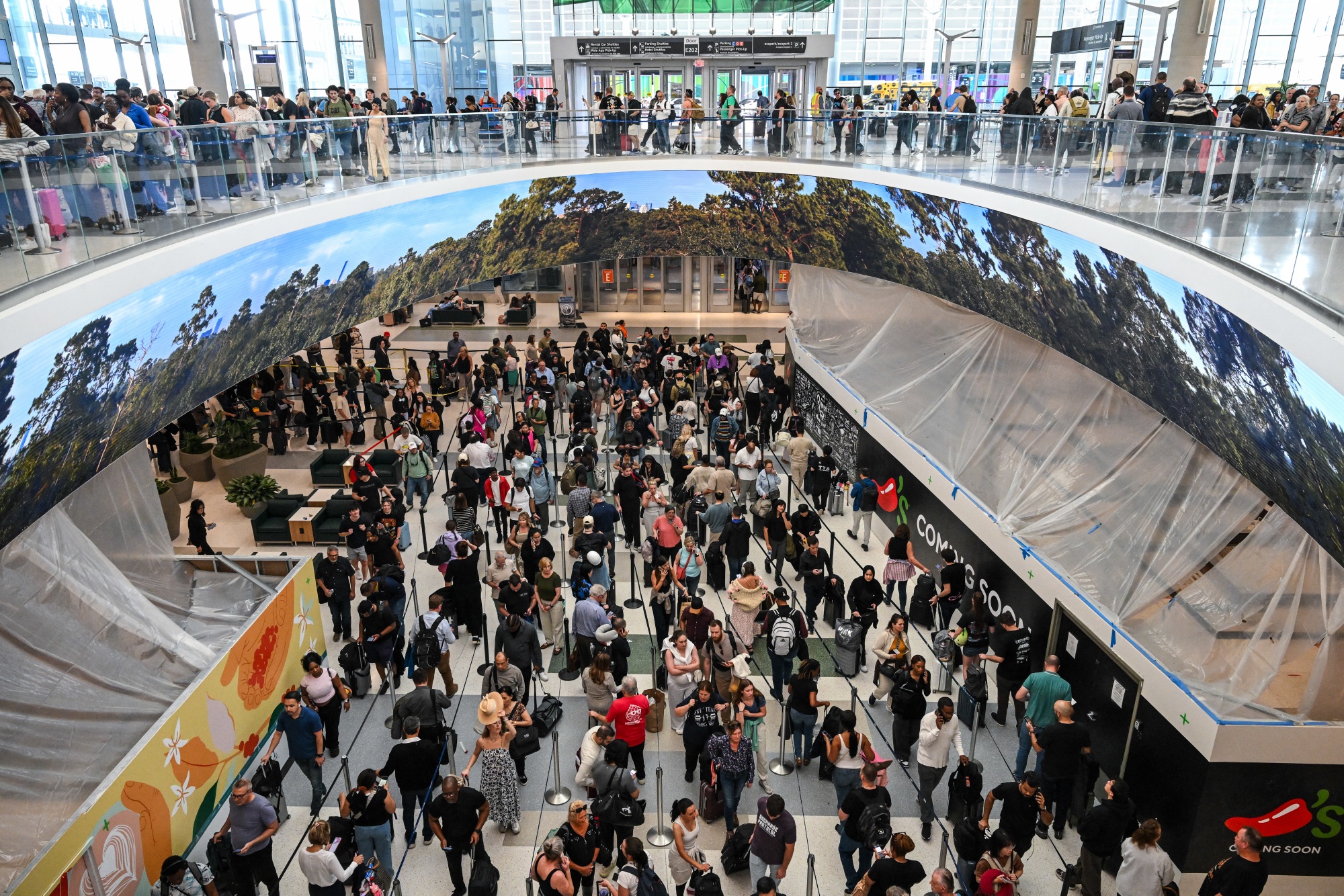 Travelers wait line to go through security at George Bush Intercontinental Airport in Houston on March 23. Photographer: Ronaldo Schemidt/AFP/Getty Images