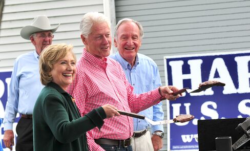 Former U.S. President Bill Clinton and his wife, former Secretary of State Hillary Rodham Clinton and U.S. Senator Tom Harkin (D-IA) flip steaks at the 37th Harkin Steak Fry.