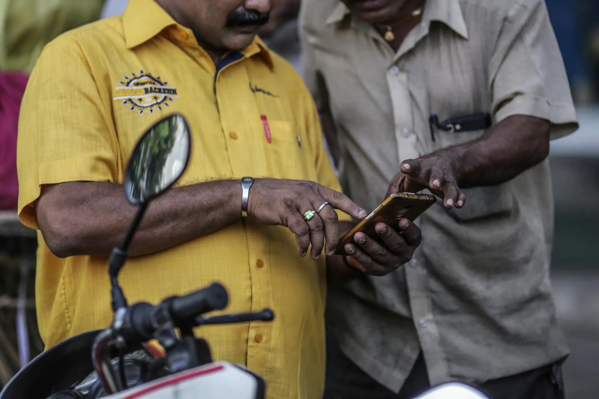 People use a smartphone in Mumbai.