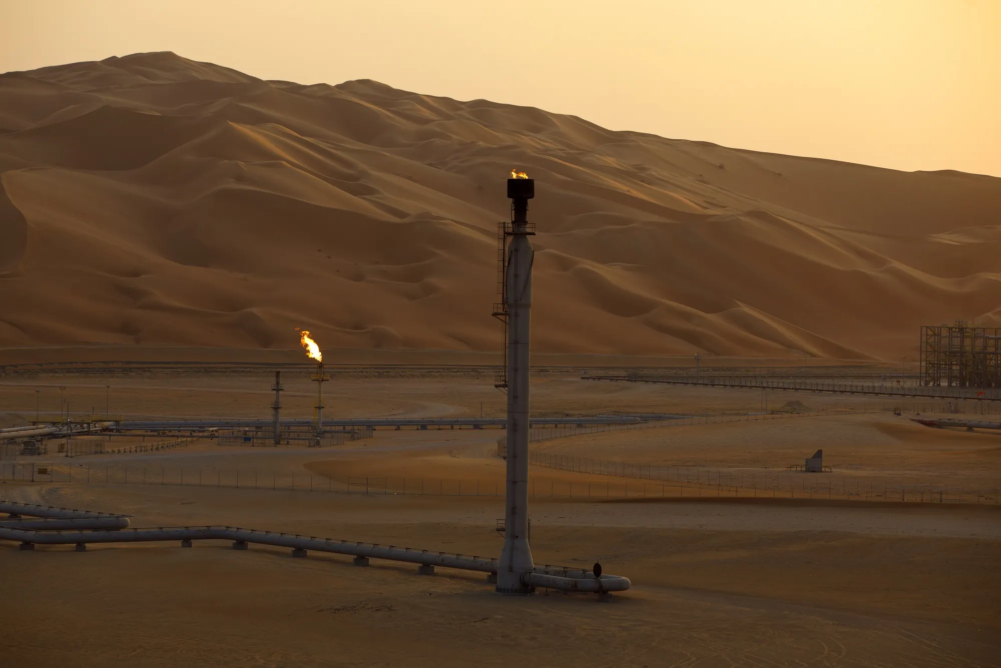 Flames burn off at an oil processing facility in Saudi Aramco's oilfield in the Rub' Al-Khali (Empty Quarter) desert in Shaybah, Saudi Arabia.