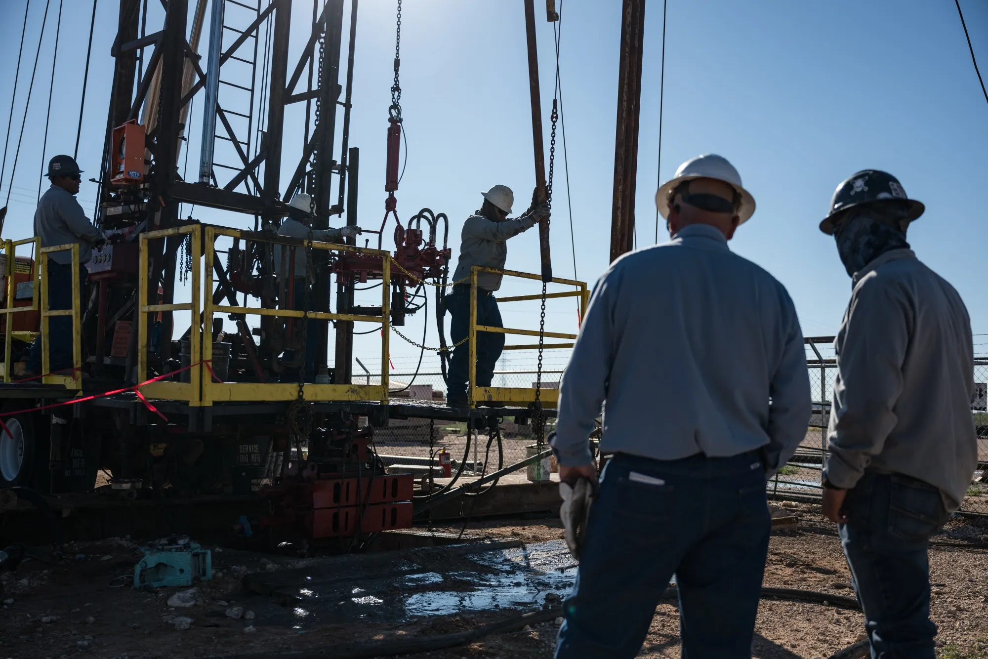 An oilfield crew works a service rig&nbsp;in Midland, Texas.