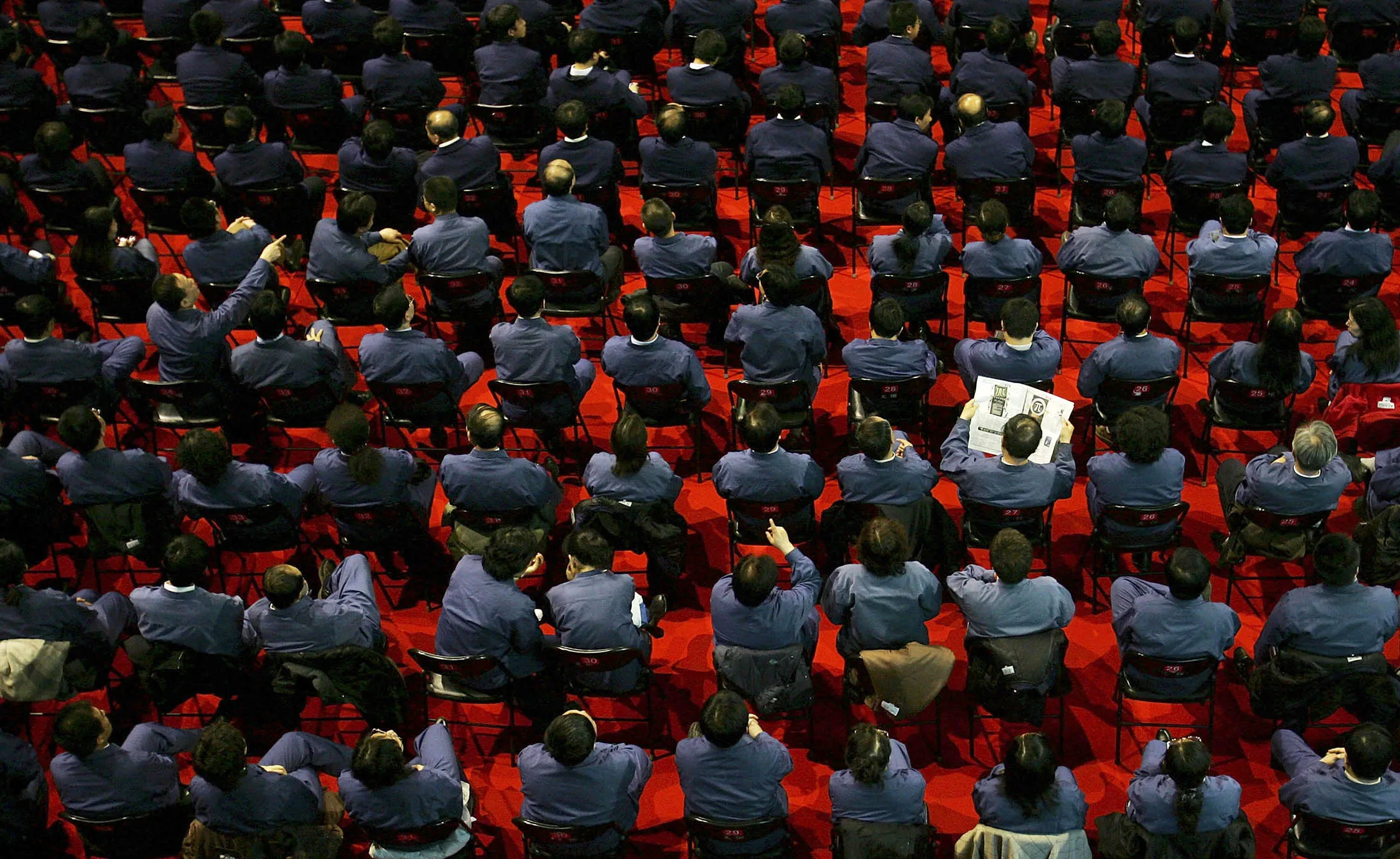 A Chinese steel worker reads a newspaper at a factory in Beijing.
