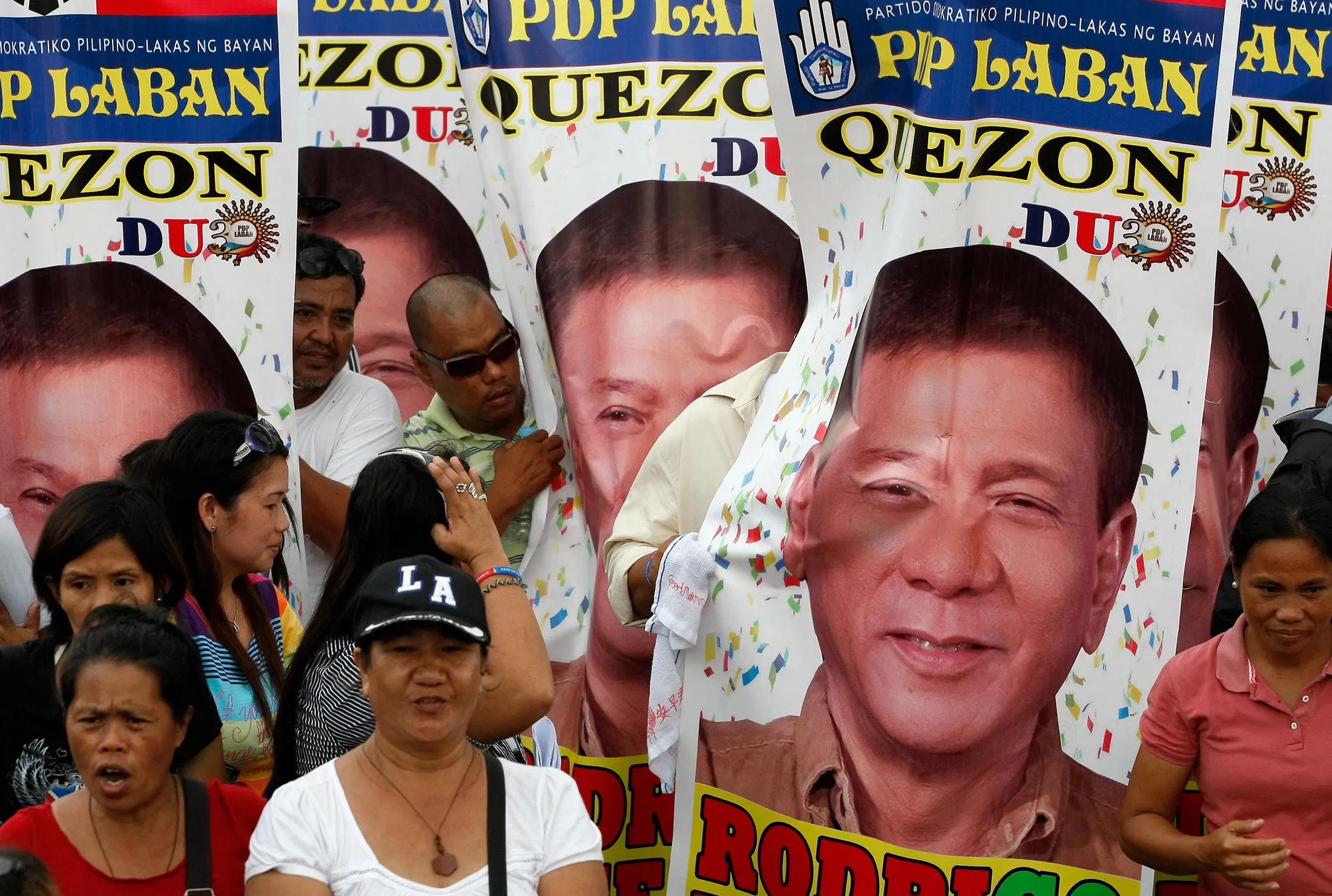 Supporters display tarpaulins of Davao city Mayor Rodrigo Duterte during a rally at Manila's Rizal Park to urge Davao city Mayor Rodrigo Duterte to run for President.

