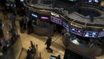 Traders are seen working on the floor of the New York Stock Exchange.