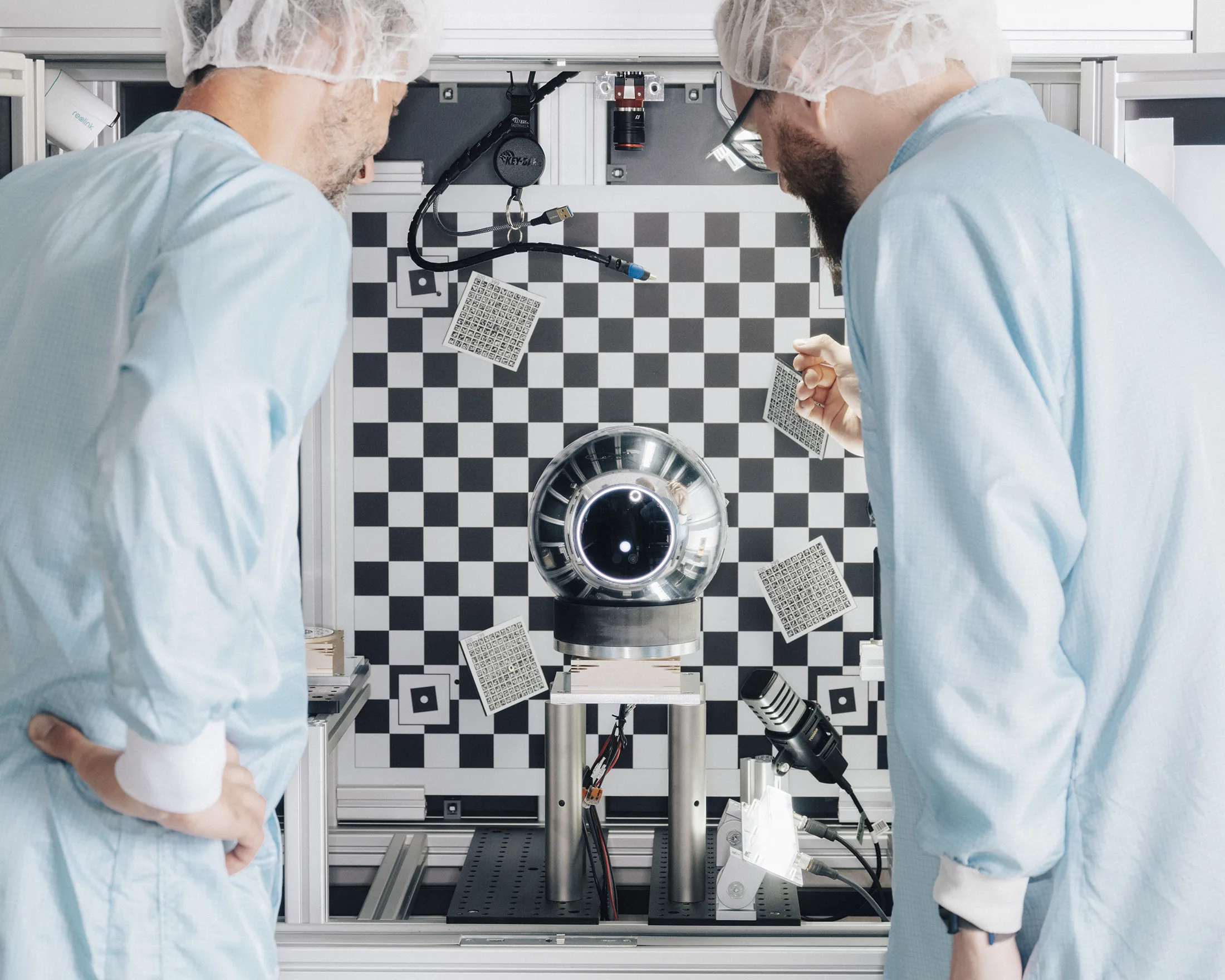 Manufacturing workers looking at the Orb.