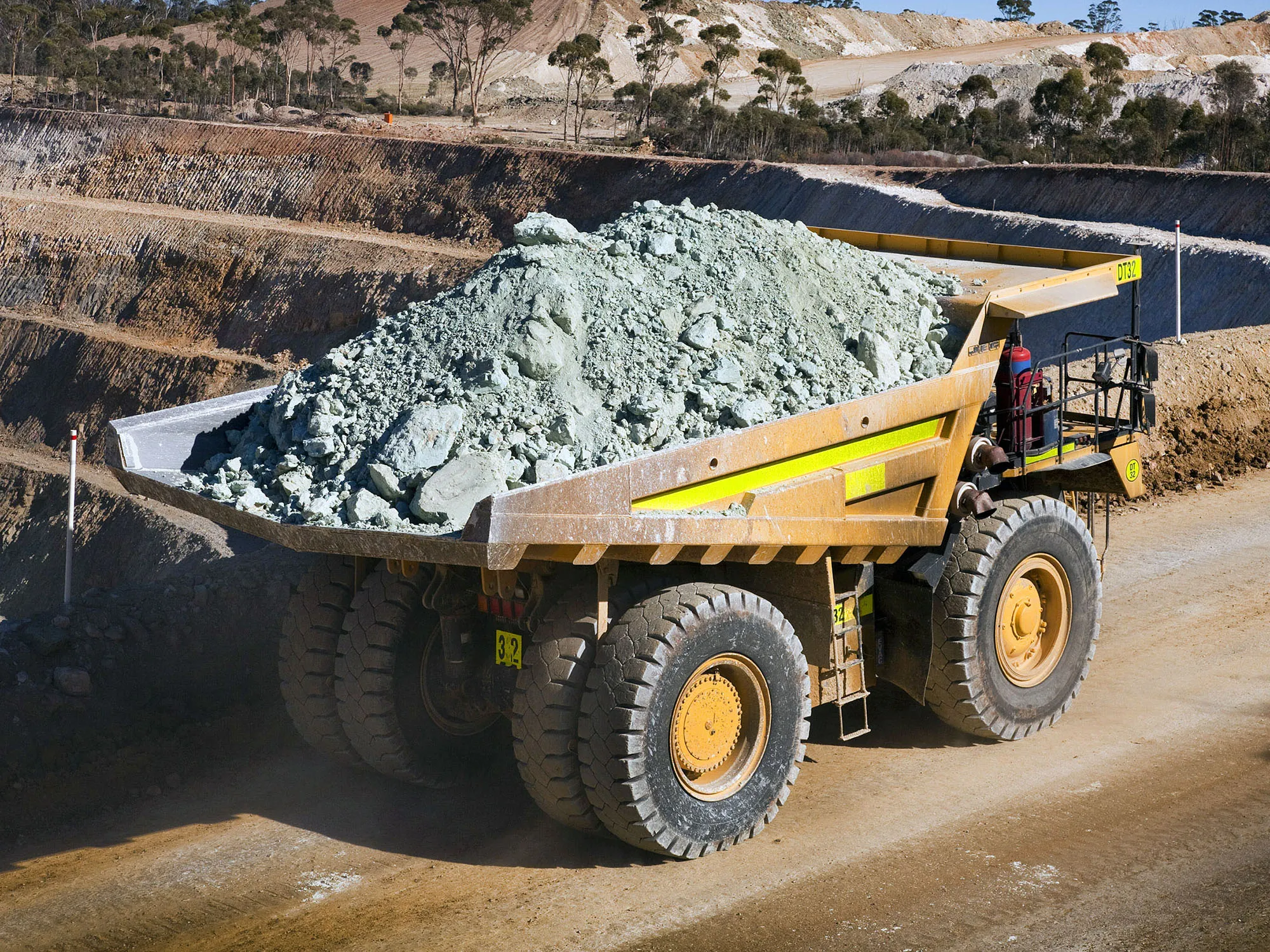 A truck carries nickel ore out of a open-cut nickel mine.