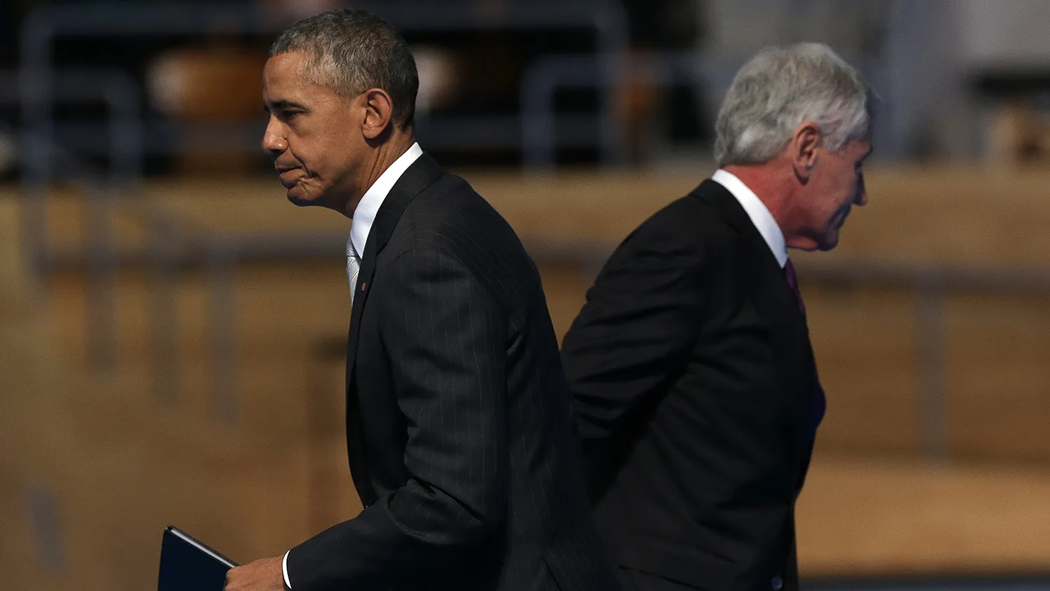 U.S. Secretary of Defense Chuck Hagel (R) and U.S. President Barack Obama pass each other during a farewell ceremony for Hagel at Fort Myer January 28, 2015 in Arlington, Virginia.
