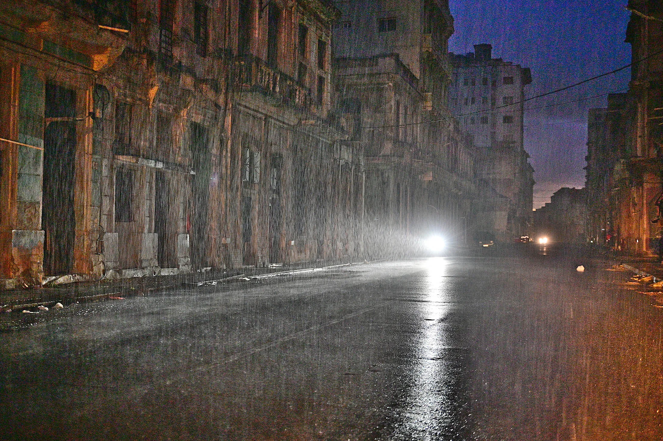 A motorcycle lights a street under pouring rain during a nationwide blackout caused by a grid failure in Havana&nbsp;on Oct.&nbsp;19.