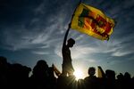 A person holds a Sri Lankan flag.
