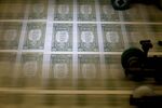50 subject one dollar note sheets are run through an intaglio printing press before the face is printed at the U.S. Bureau of Engraving and Printing in Washington, D.C., U.S., on Tuesday, April 14, 2015. Republican efforts to pass a fiscal year 2016 budget cleared another hurdle as the House named its members to a conference committee and Senate Majority Leader Mitch McConnell pledged to do the same by the end of the week.