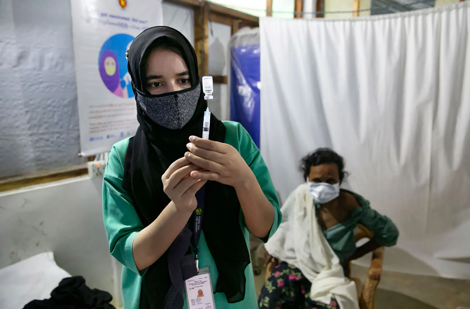 A nurse prepares a Covid-19 vaccine in a Rohingya refugee camp with the help of the UN agencies.&nbsp;