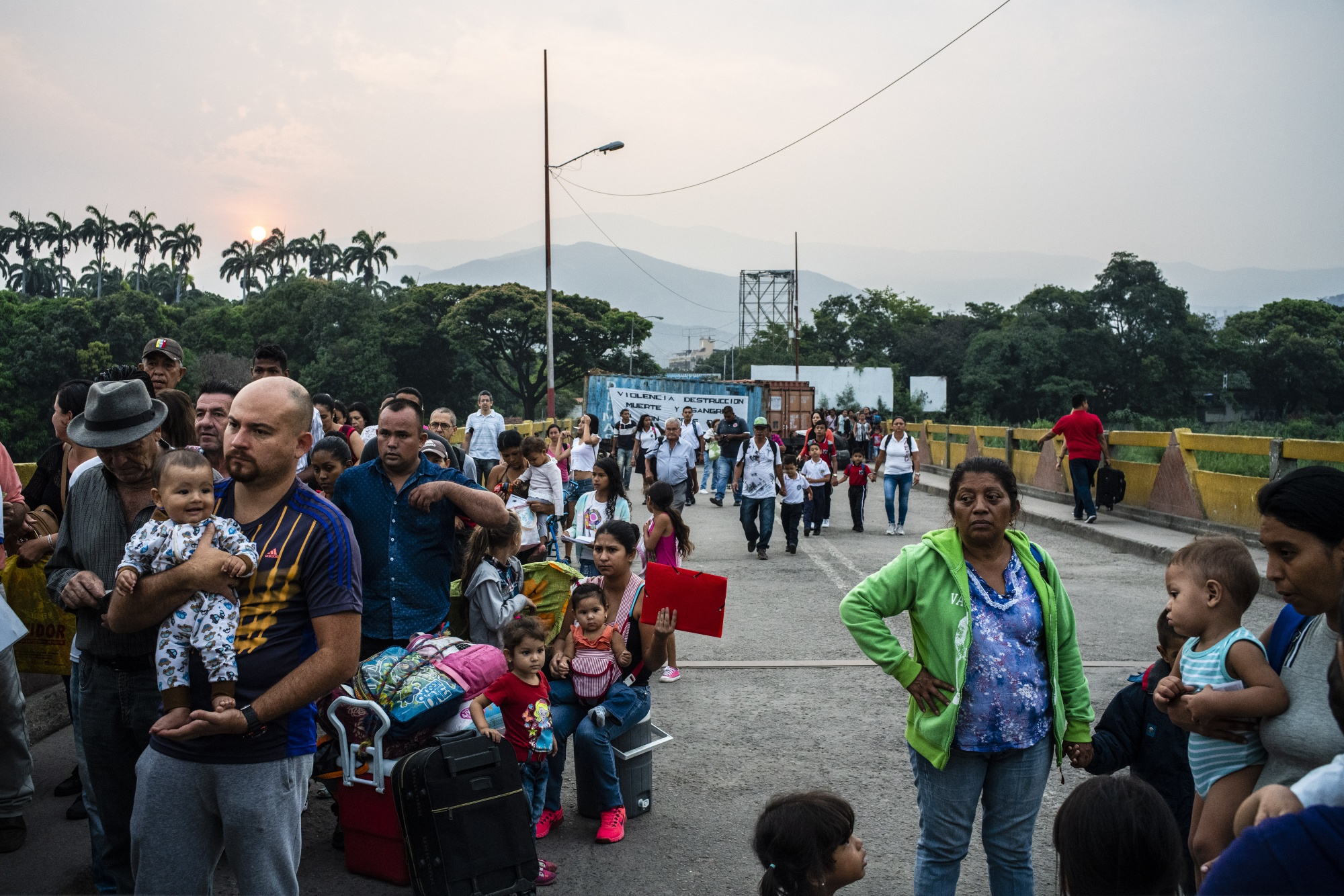 Venezuelans stop at a Colombian migration checkpoint while crossing the Simon Bolivar International Bridge near the Venezuelan border in Cúcuta, Colombia, on Wednesday, March 27, 2019. 