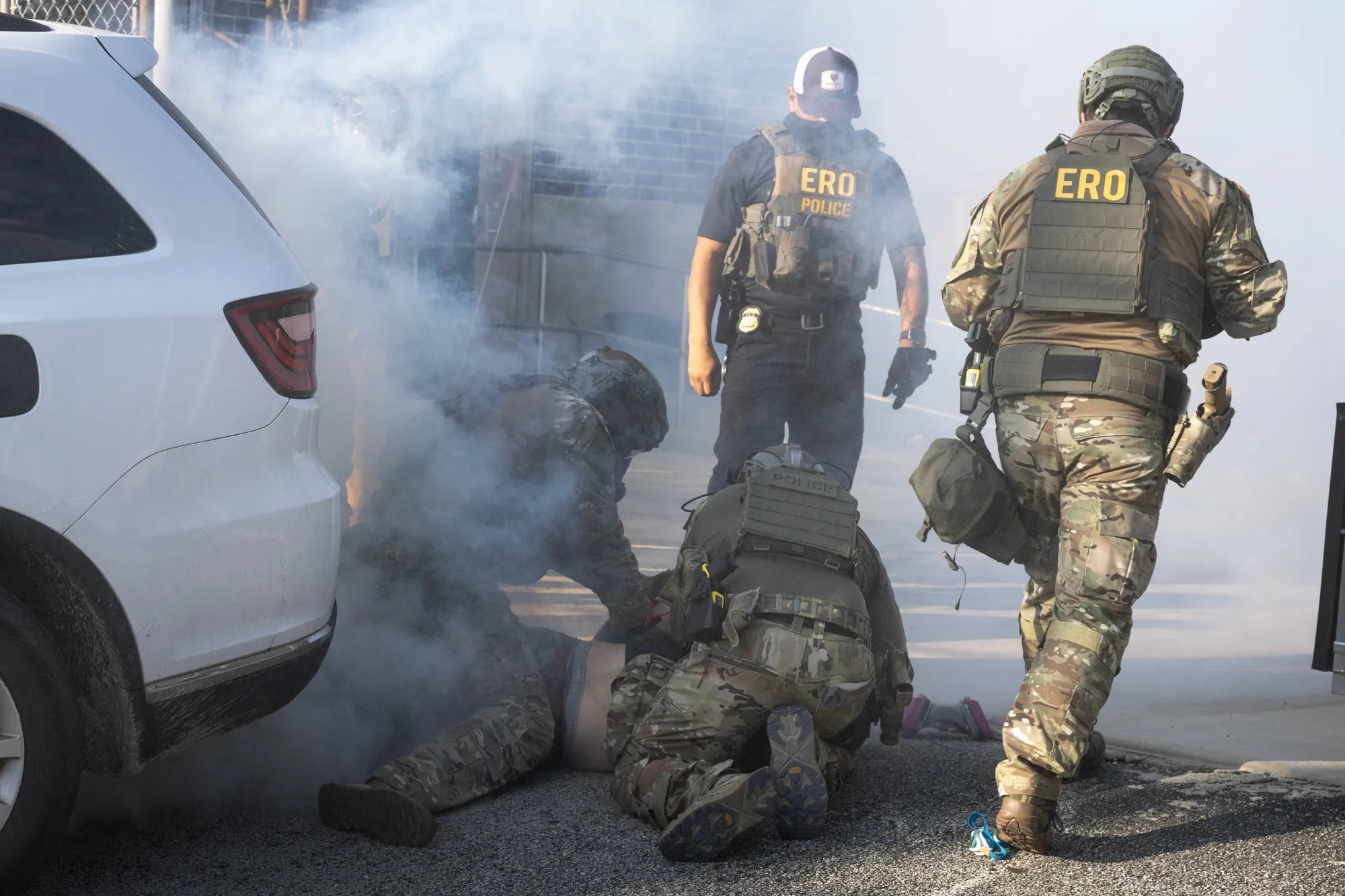 A demonstrator is taken into custody by federal law enforcement agents as tear gas fills the air during a protest outside of an immigration processing center in Broadview, Illinois, on Sept.&nbsp;19.