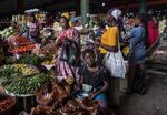 Customers purchase fresh produce at the Adjame vegetable market in Abidjan, Ivory Coast.