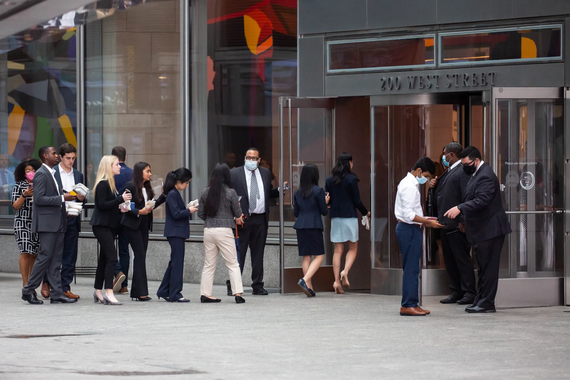 People wait in line to enter outside the Goldman Sachs headquarters building in New York, U.S.