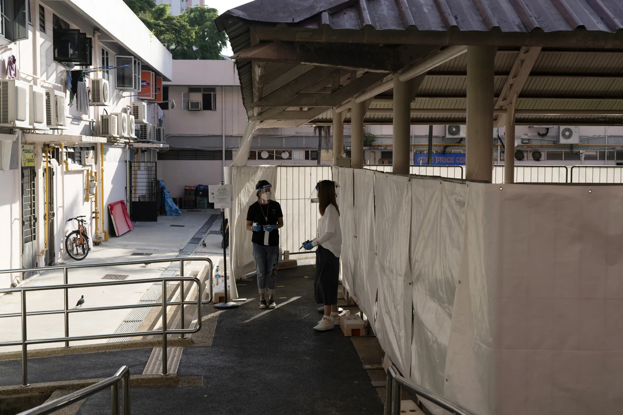 Health workers outside a mandatory Covid-19 test site set up at a&nbsp;public housing estate in the Redhill area of Singapore on June 21.