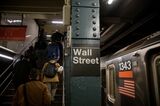 Commuters exit a Wall Street subway station.