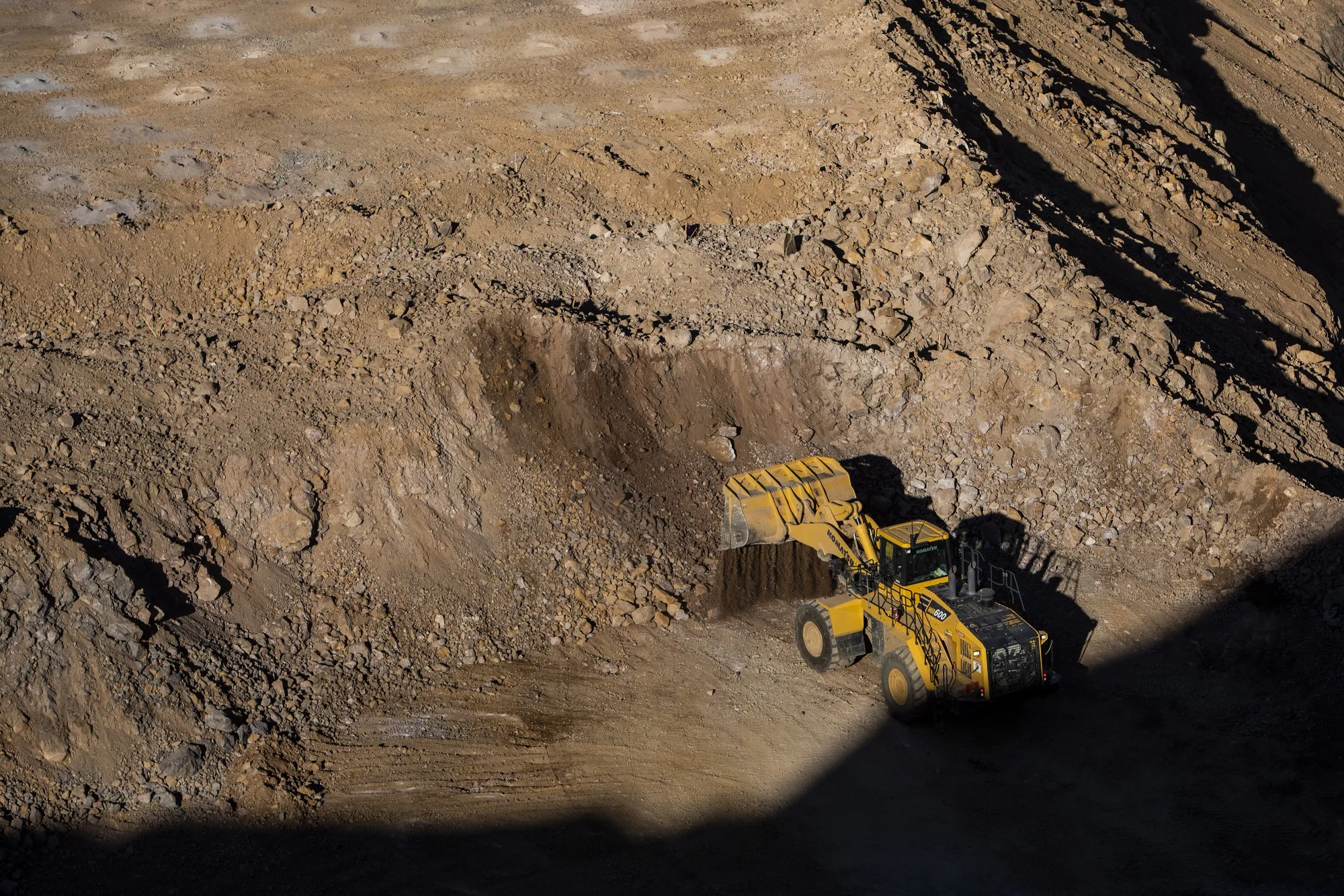 A wheel loader moves raw ore inside the pit at the Mountain Pass mine, operated by MP Materials, in Mountain Pass, California.