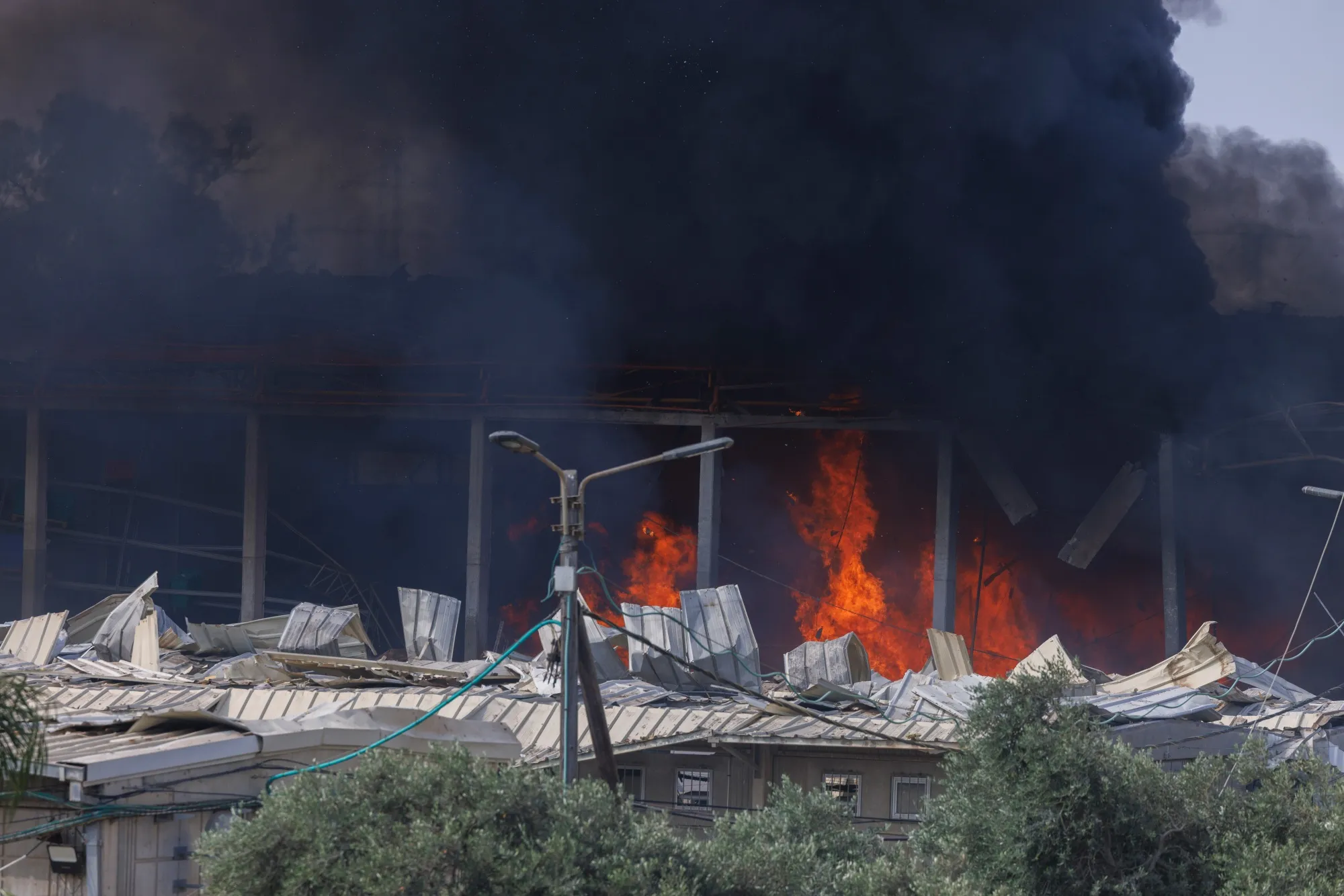 Fire and smoke from an Iranian missile strike in Hertzliya, Israel, on Tuesday, June 17, 2025.