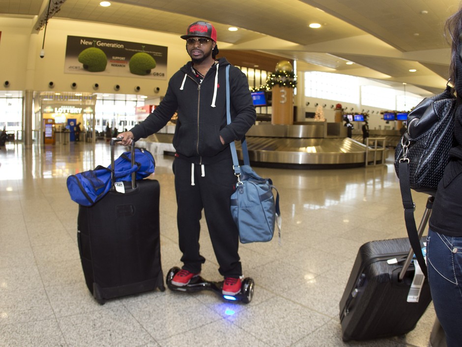 An airline passenger rides a hoverboard after claiming his luggage at Hartsfield Jackson Atlanta International Airport on December 11.