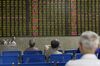 Investors sit in front of an electronic stock board at a securities brokerage in Shanghai, China, on Wednesday, May 30, 2018. Foreign investors are about to get a bargain. At least, that's the optimistic slant after Chinese equities slumped for the longest stretch since 2013, taking valuations back to two-year lows right before they feature on MSCI Inc. indexes from June 1.