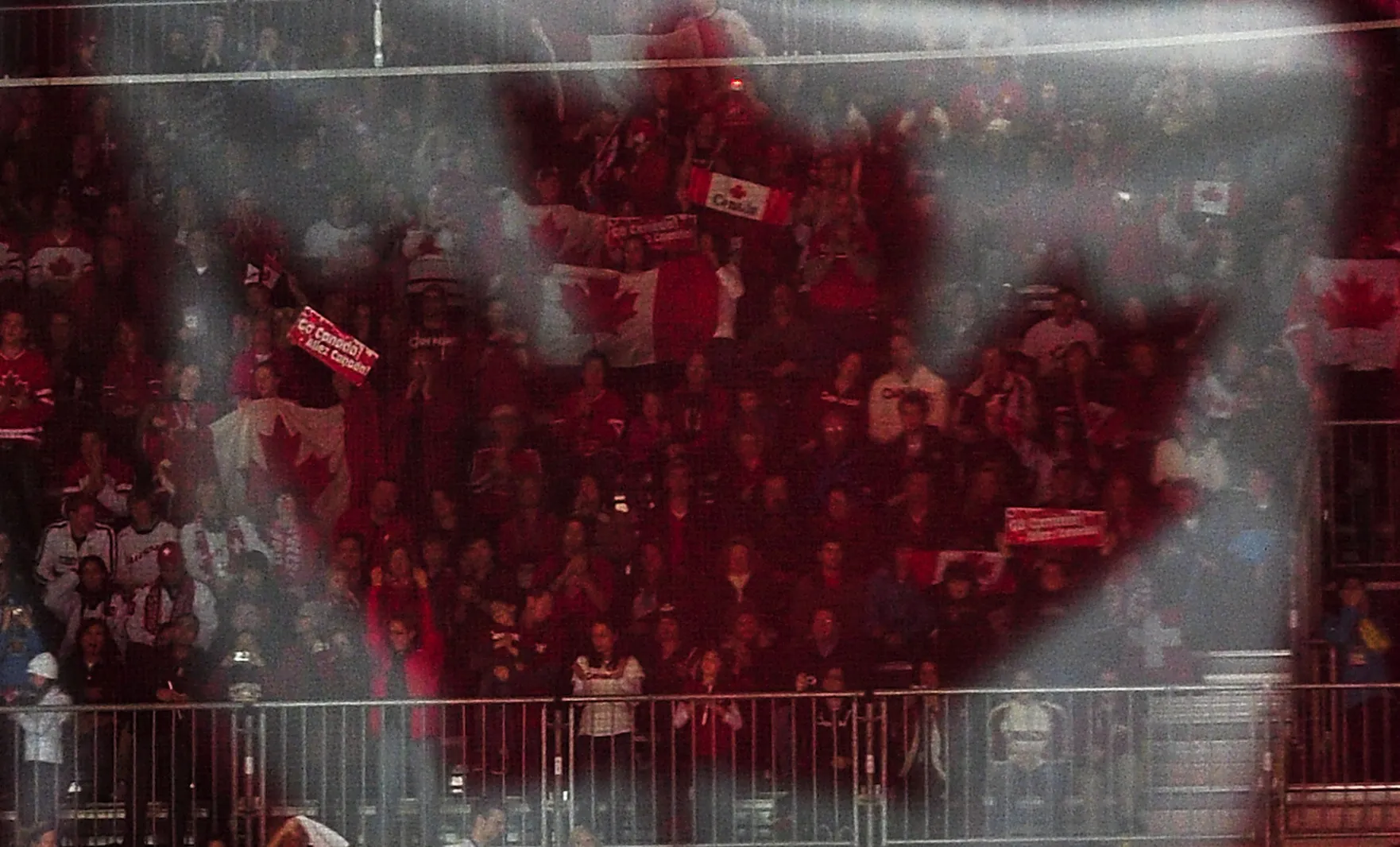 The Canada National Flag is reflected in glass over fans.&nbsp;