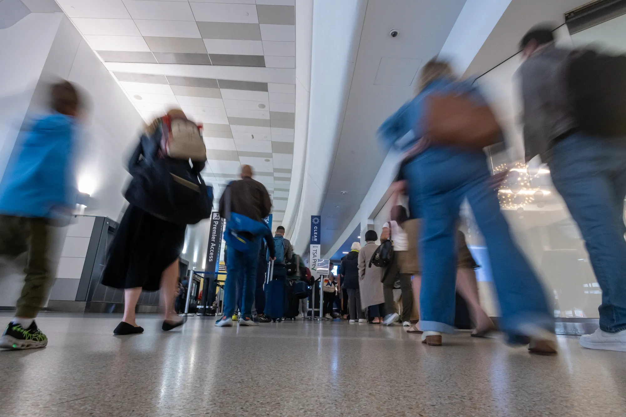 Travelers wait to go through security at San Francisco International Airport (SFO) in San Francisco, California.
