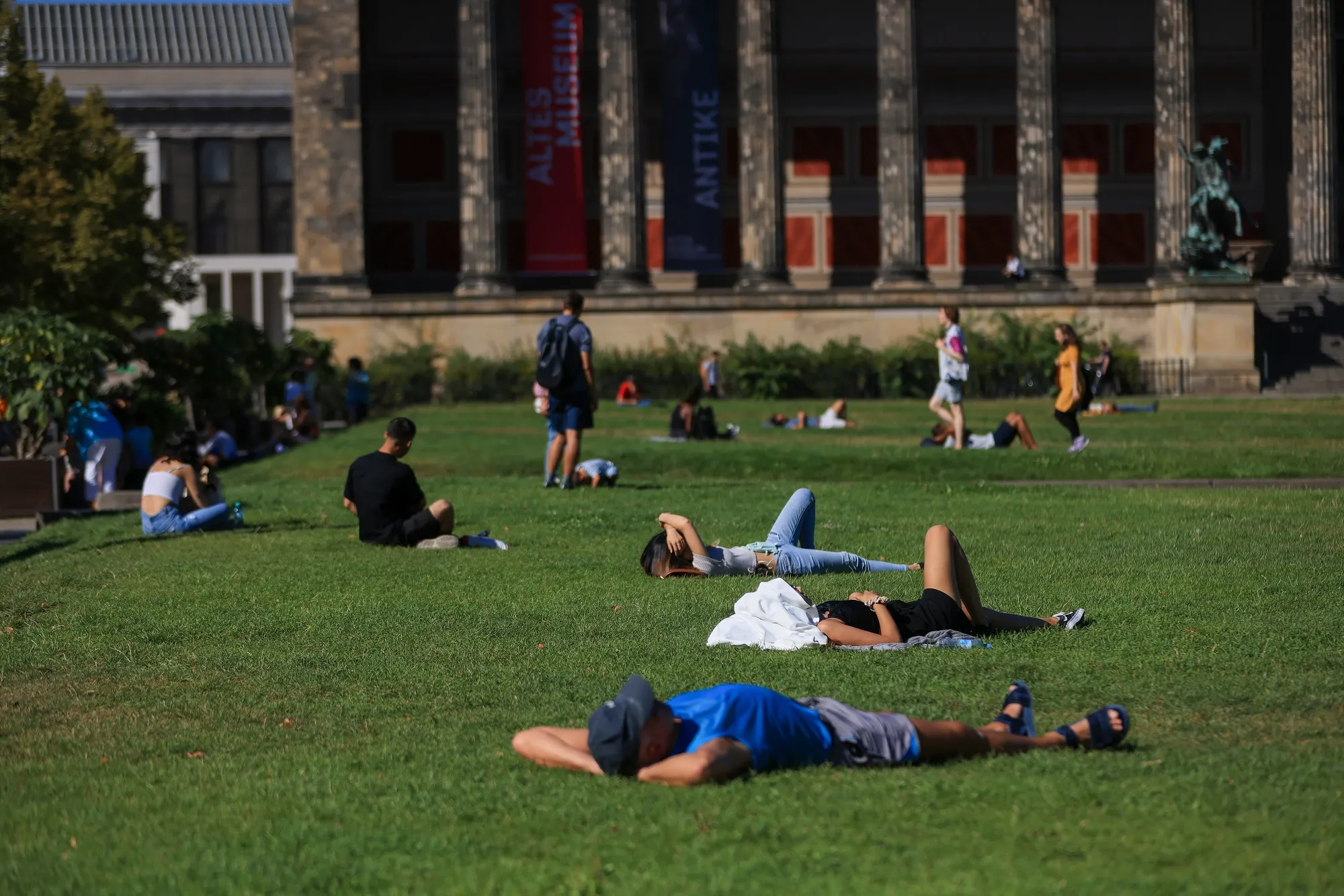 Tourists rest in gardens near the Altes Museum in Berlin in September.