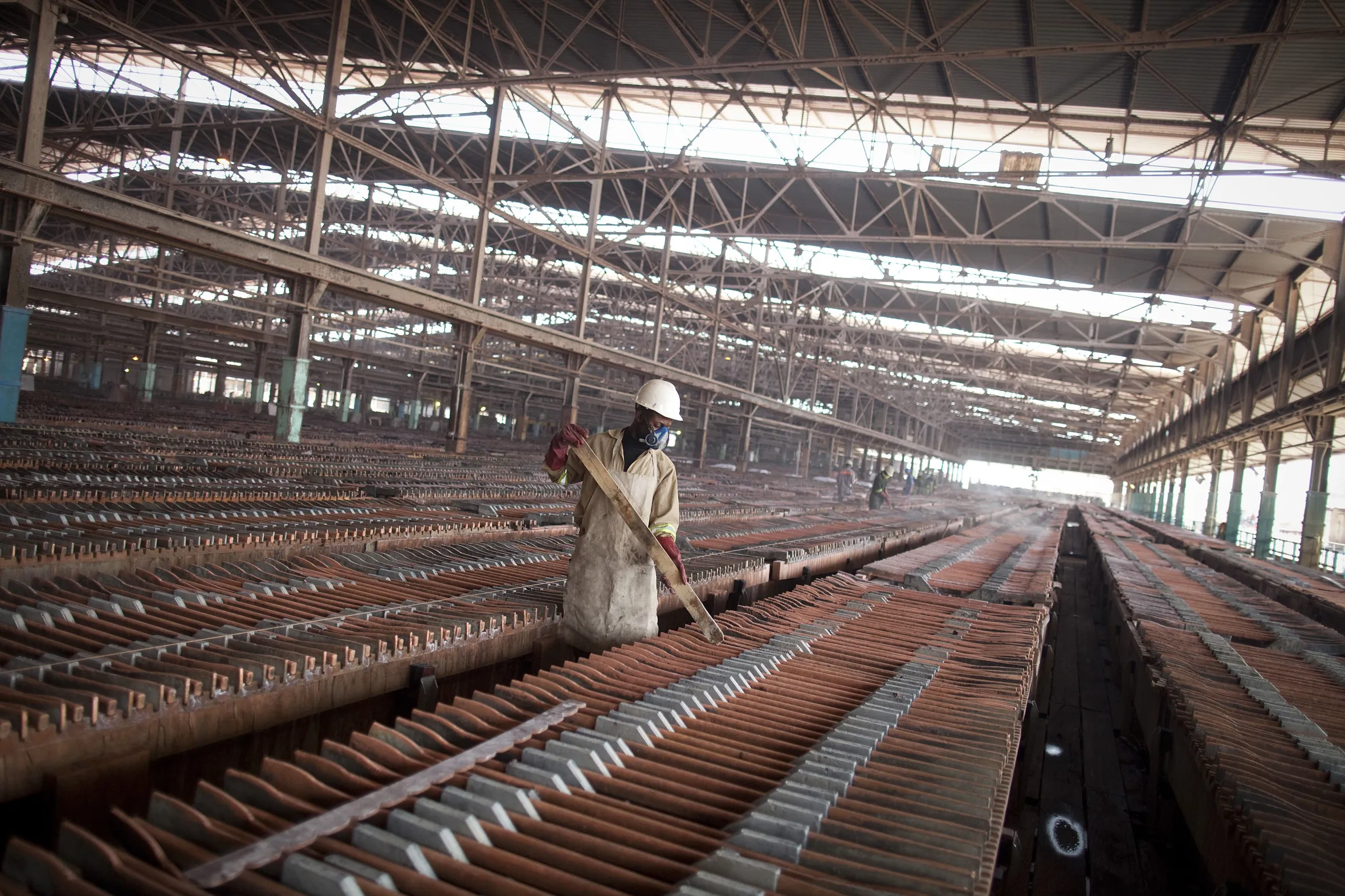 A worker handles copper sheets at a&nbsp;copper and cobalt mine in Kolwezi, Democratic Republic of Congo.