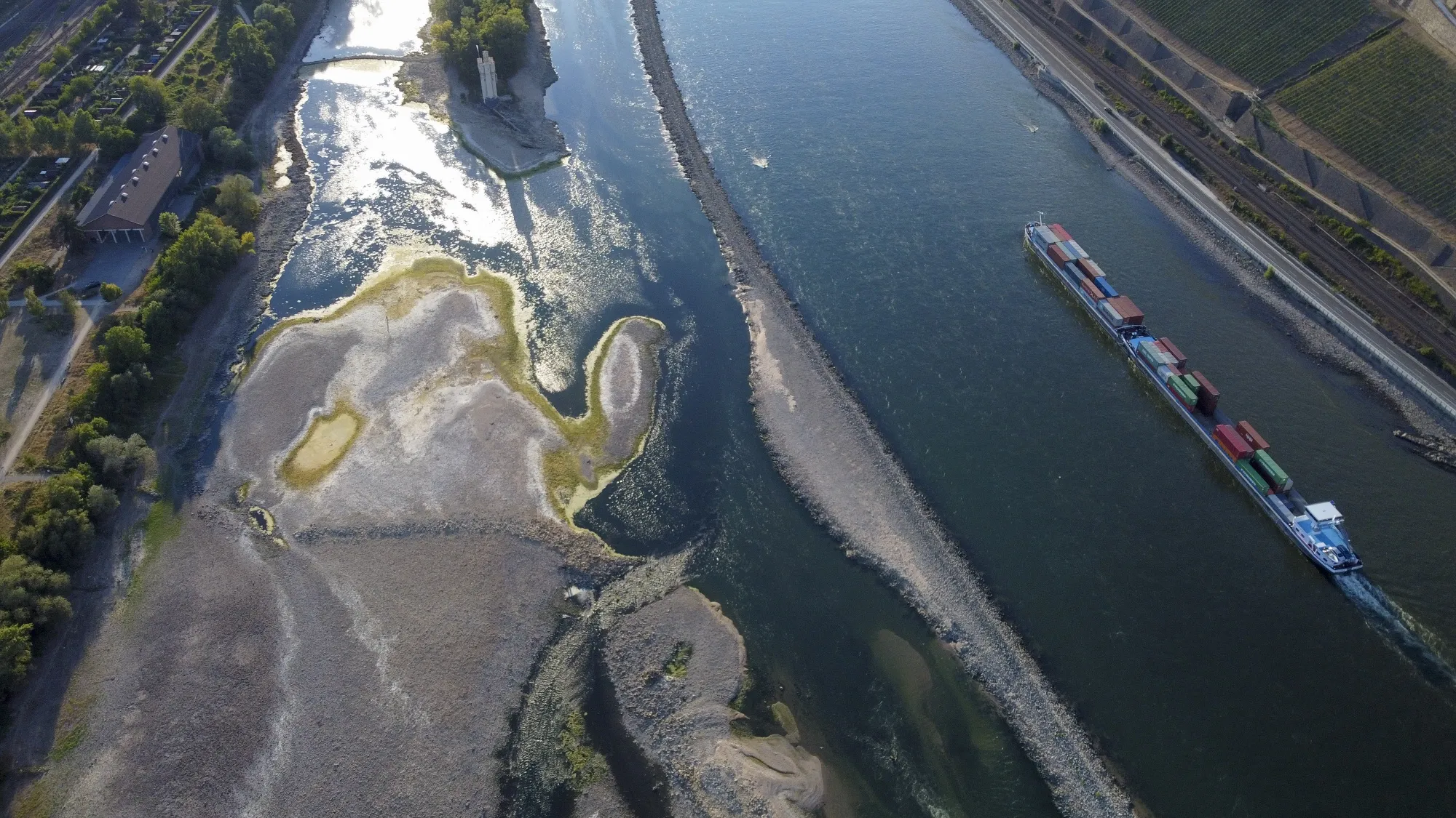A barge travels past exposed riverbed on the River Rhine near Bingen, Germany, on&nbsp;Aug. 12.