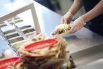 An employee prepares a burrito bowl at a Chipotle Mexican Grill Inc. restaurant in Louisville, Kentucky, U.S.