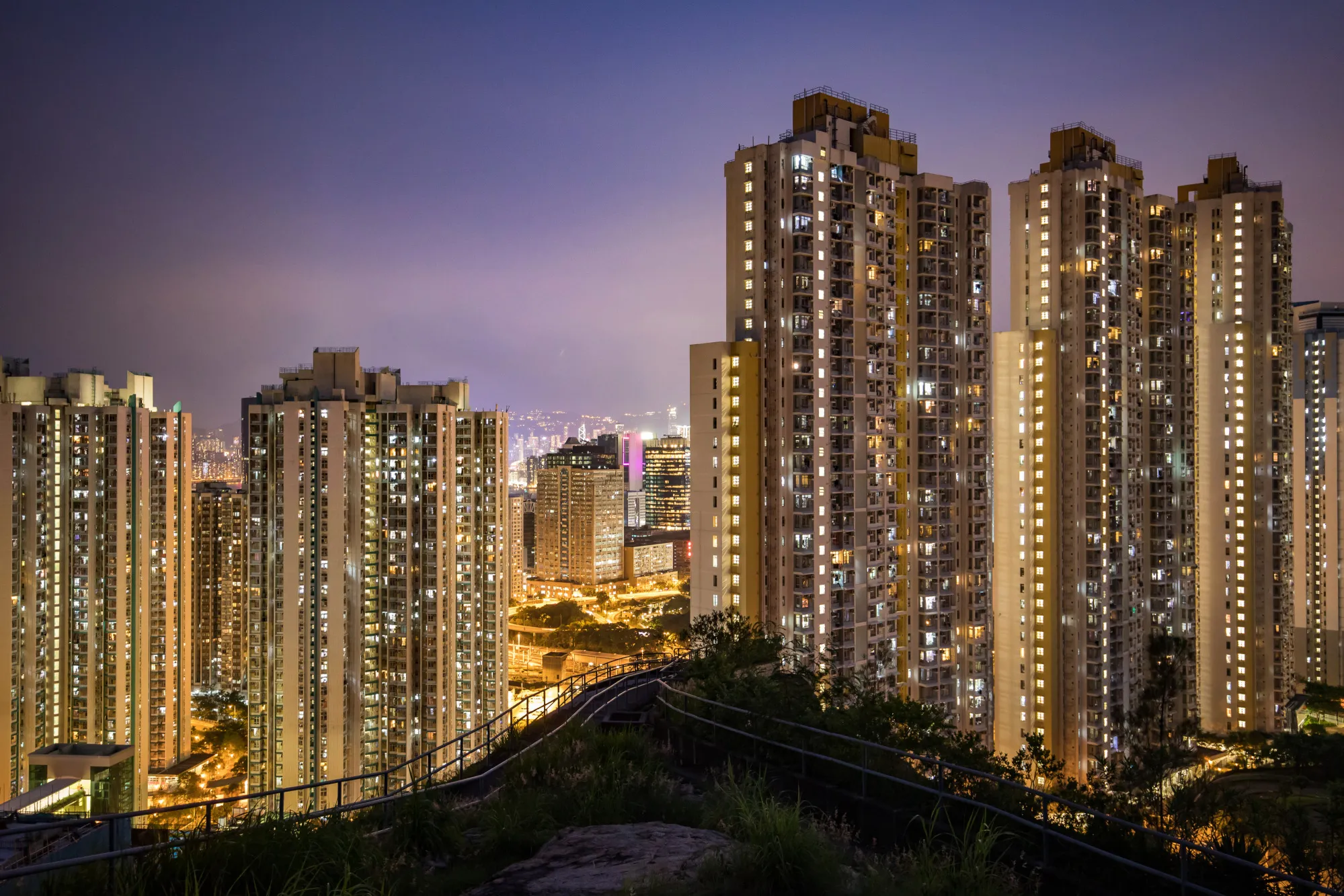 Residential buildings stand illuminated&nbsp;in Hong Kong.