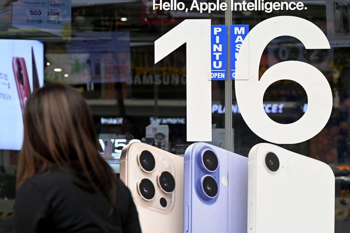 An Apple iPhone 16 advertisement at a store in Bali.