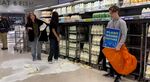 Supporters of Animal Rebellion pouring out milk in a Waitrose in Edinburgh, Oct. 15.