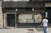 Lenox Lounge in 2016, shut down. Man walking his dog in front.