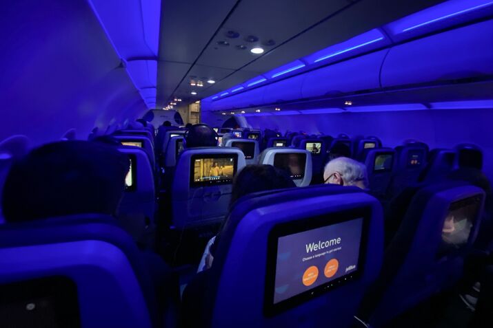 Airplane cabin with in flight entertainment screens lit up, jetblue, New York
