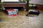 Houses and vehicles at the Highland Glen subdivision stand in floodwaters due to Hurricane Harvey.