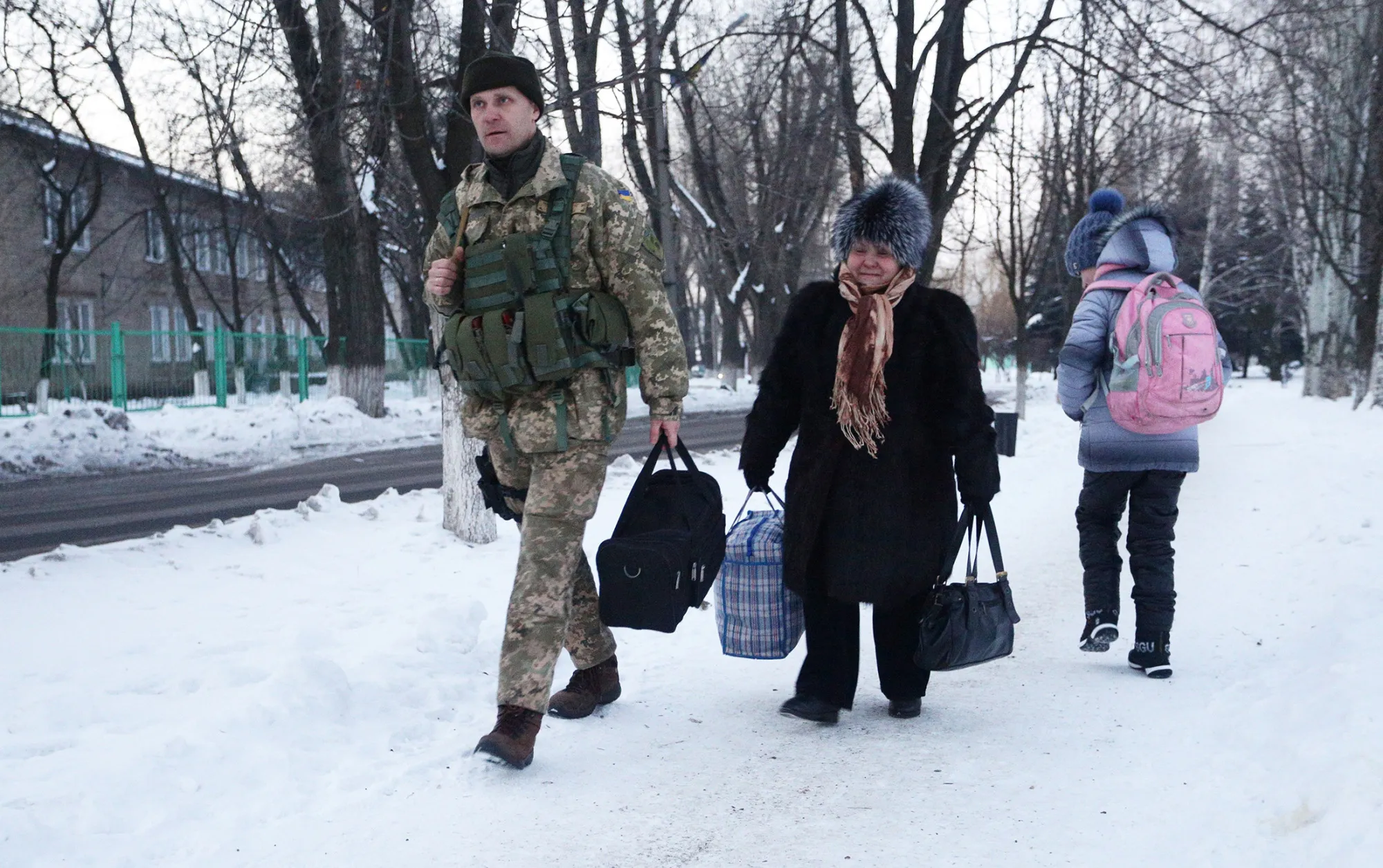 An Ukrainian serviceman helps a local resident in the town of Avdiivka in the Donetsk region on Jan. 31.
